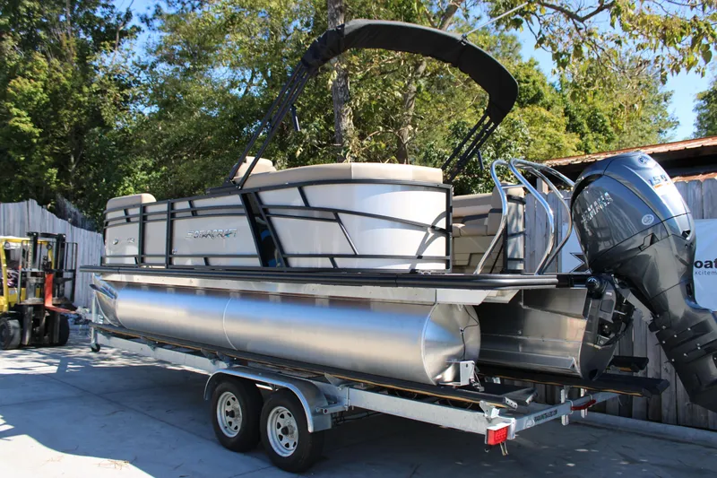Slide: The Image of 2026 Starcraft EXS 1 pontoon boat on trailer, featuring Yamaha outboard motor. - 3