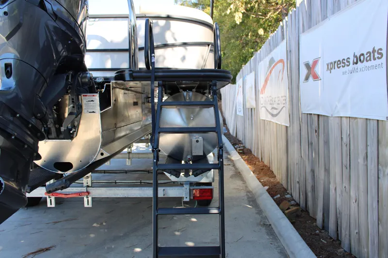 Slide: The Image of Rear view of 2026 Starcraft EXS 1 boat with ladder and motor, parked on trailer. - 5