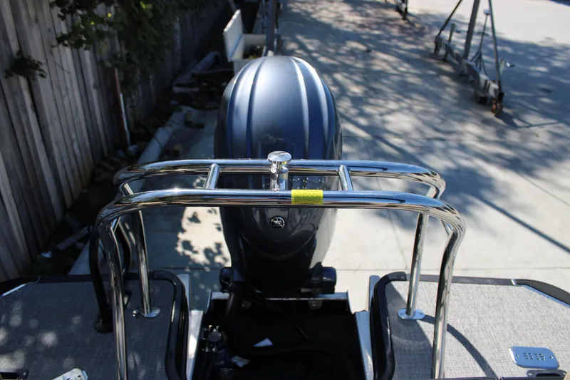 Slide: The Image of Rear view of 2026 Starcraft EXS 1 boat with chrome railing and outboard motor. - 6