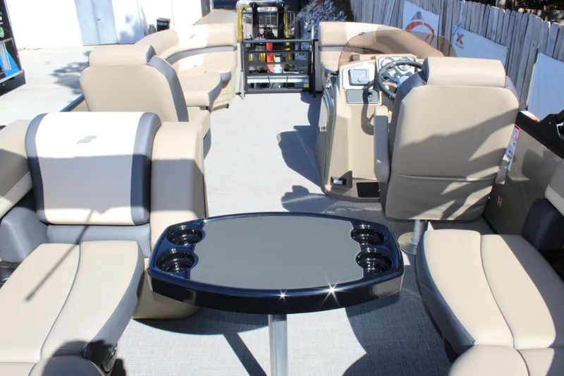 Slide: The Image of Interior of 2026 Starcraft EXS 1 boat with beige seating and black table. - 7