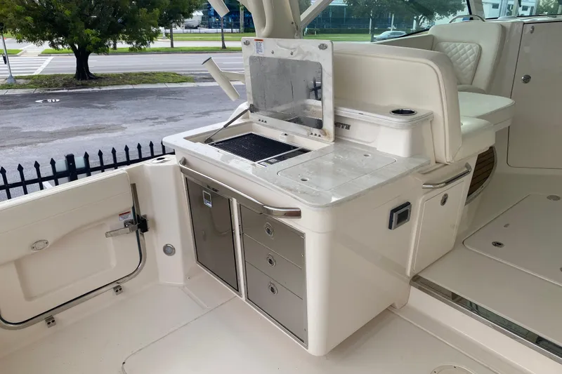 Slide: The Image of 2025 Grady-White Freedom 345 boat interior with outdoor kitchen and storage drawers. - 16