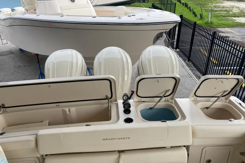 Slide: The Image of 2025 Grady-White Freedom 345 boat with open storage compartments and four engines. - 19