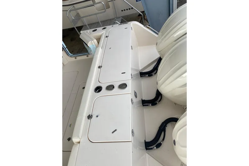Slide: The Image of 2025 Grady-White Freedom 345 boat deck with dual outboard engines and storage compartments. - 23