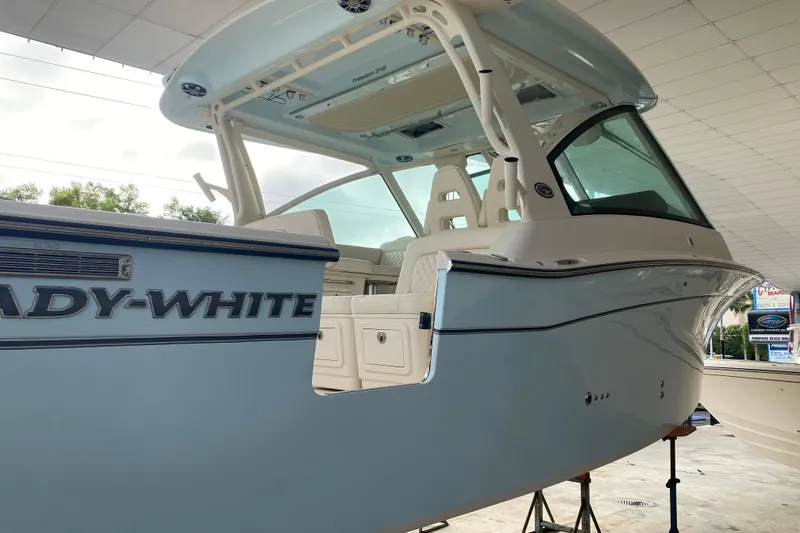 Slide: The Image of 2025 Grady-White Freedom 345 boat, sleek design, spacious interior, under a covered area. - 3
