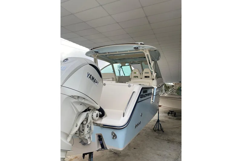 Slide: The Image of 2025 Grady-White Freedom 345 boat with Yamaha engine in a covered area. - 4