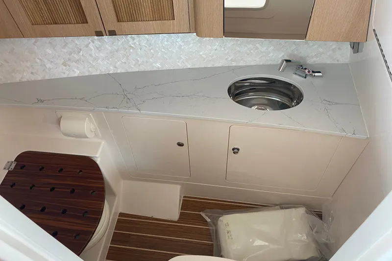 Slide: The Image of Luxurious bathroom interior of 2025 Grady-White Freedom 345 boat with modern sink and wood accents. - 8