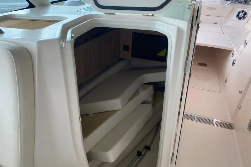 Slide: The Image of 2025 Grady-White Freedom 345 boat interior with storage compartment and seating area. - 9