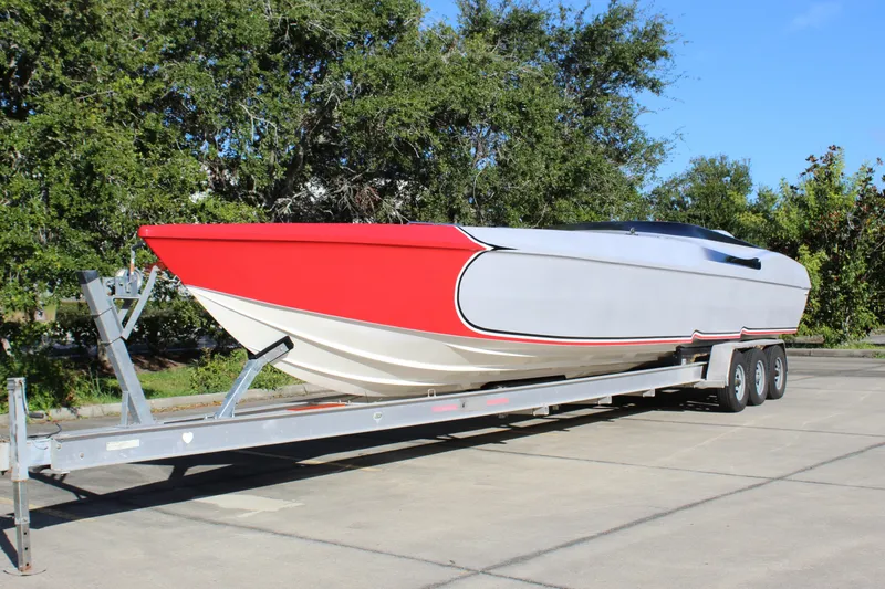 The Image of 2007 Chaudron 41 SS powerboat on trailer, featuring sleek red and white design. - 0