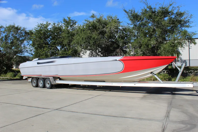 Slide: The Image of 2007 Chaudron 41 SS powerboat on trailer, featuring sleek red and gray design. - 10