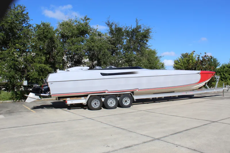 Slide: The Image of 2007 Chaudron 41 SS powerboat on trailer, parked outdoors under clear blue sky. - 12