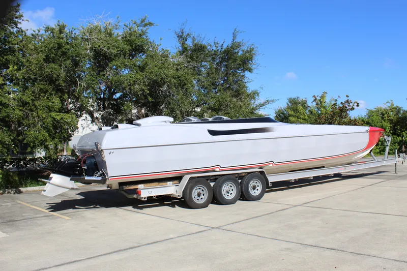 Slide: The Image of 2007 Chaudron 41 SS powerboat on trailer, parked outdoors under clear blue sky. - 13