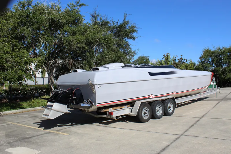 Slide: The Image of 2007 Chaudron 41 SS powerboat on trailer, parked outdoors under clear blue sky. - 14