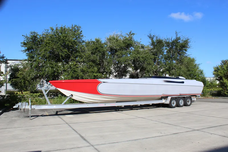 Slide: The Image of 2007 Chaudron 41 SS powerboat on trailer, red and white design, parked outdoors. - 2