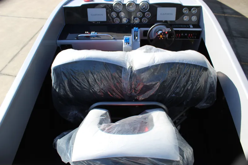 Slide: The Image of Interior of 2007 Chaudron 41 SS boat with covered seats and Garmin dashboard. - 25