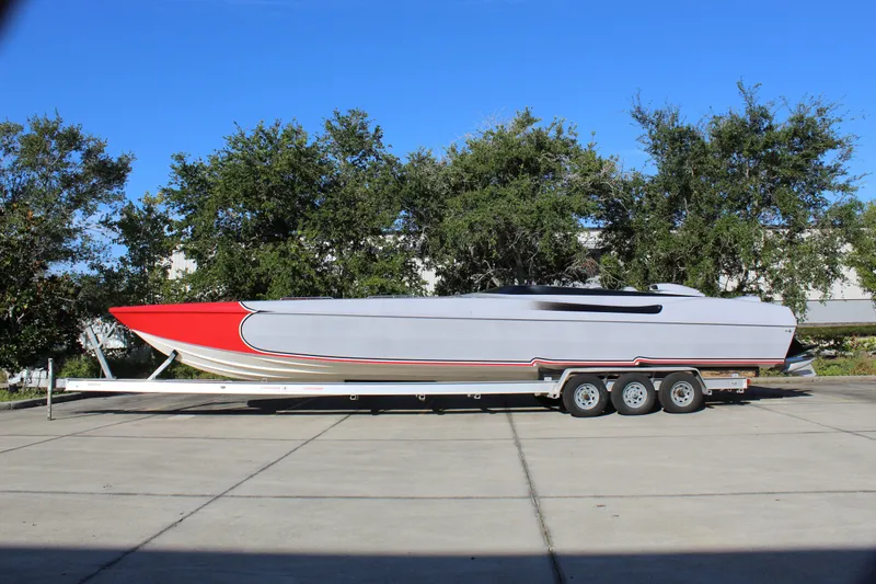 Slide: The Image of 2007 Chaudron 41 SS powerboat on trailer, red and gray design, parked outdoors. - 3