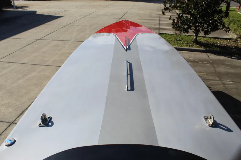 Slide: The Image of 2007 Chaudron 41 SS boat deck with red and gray design, parked on concrete. - 31