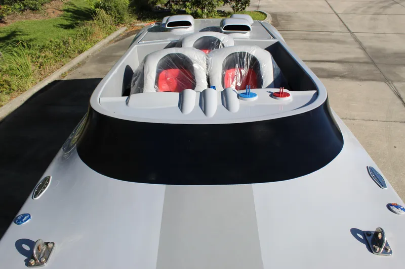 Slide: The Image of 2007 Chaudron 41 SS speedboat with sleek design and dual seating, parked on pavement. - 33