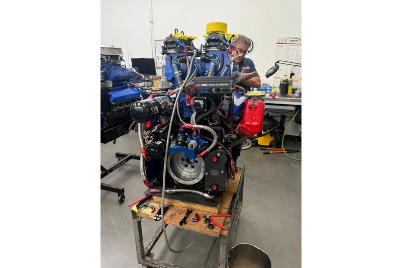 Slide: The Image of Mechanic working on Chaudron 41 SS engine, 2007 model, in a workshop setting. - 47