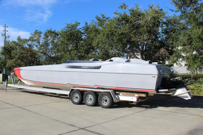 Slide: The Image of 2007 Chaudron 41 SS powerboat on trailer, parked outdoors with trees in background. - 5