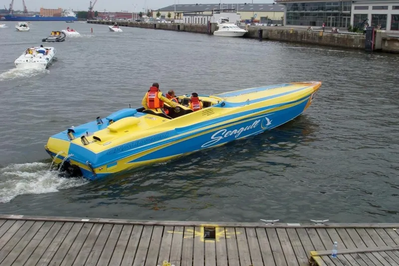 Slide: The Image of 2007 Chaudron 41 SS speedboat in vibrant blue and yellow on a busy waterway. - 51