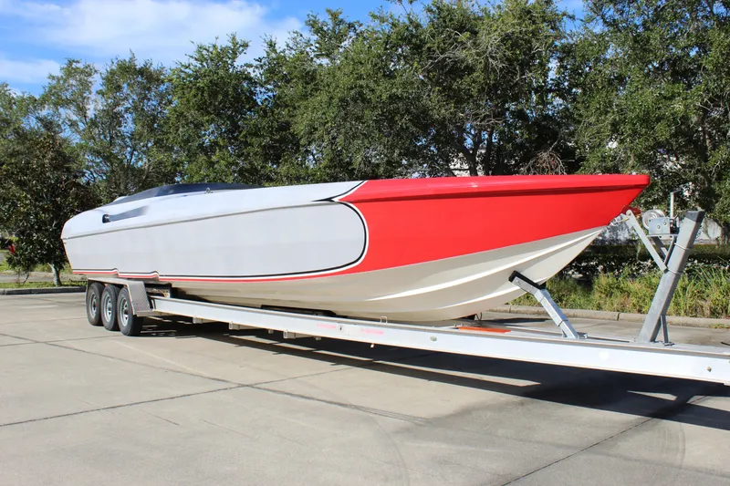 Slide: The Image of 2007 Chaudron 41 SS speedboat on trailer, featuring sleek red and white design. - 8