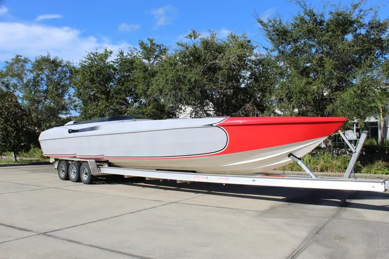Slide: The Image of 2007 Chaudron 41 SS powerboat on trailer, featuring sleek red and white design. - 9