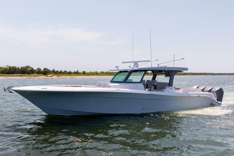 Slide: The Image of HCB 48 Campeon 2026 cruising on open water with bridge in background. - 0