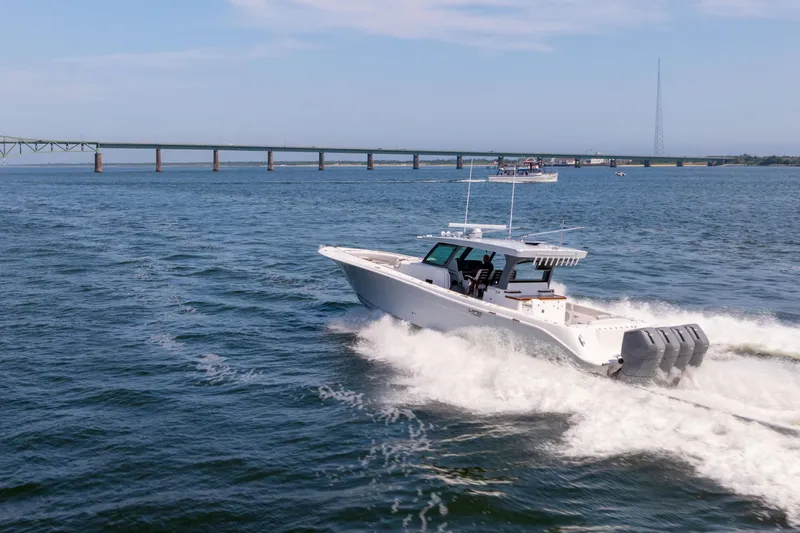 Slide: The Image of 2026 HCB 48 Campeon boat with four powerful engines on open water. - 1