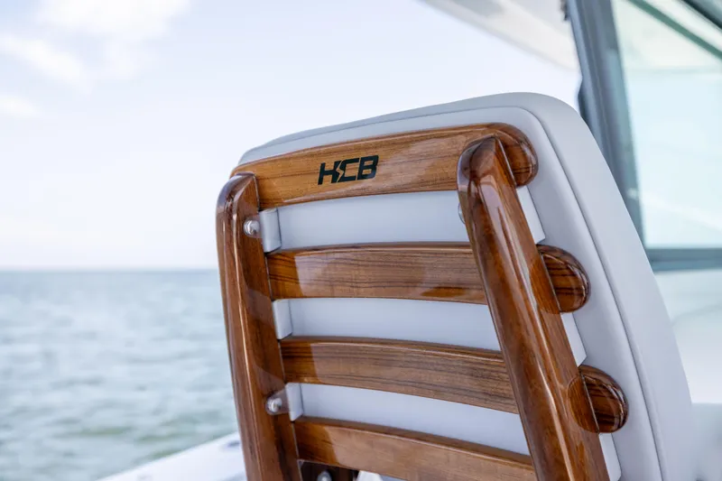 Slide: The Image of Wooden seat detail on 2026 HCB 48 Campeon boat, ocean background. - 12