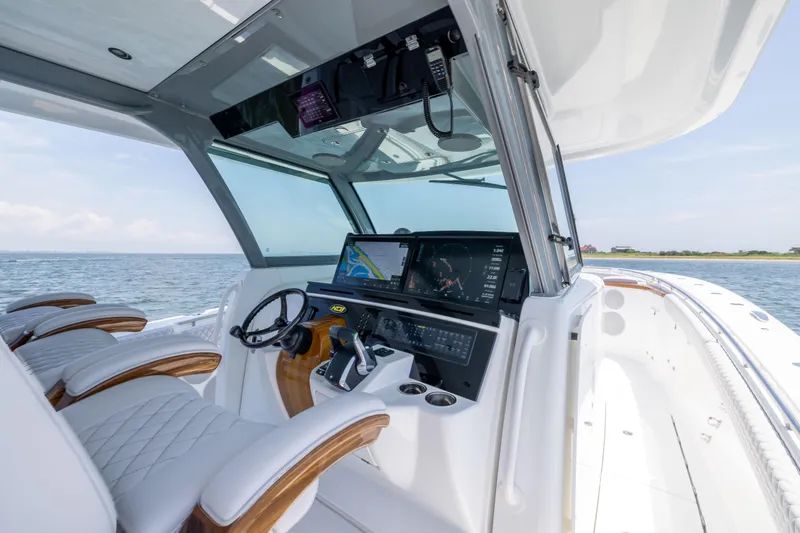 Slide: The Image of 2026 HCB 48 Campeon boat cockpit with advanced navigation system and luxurious seating. - 13