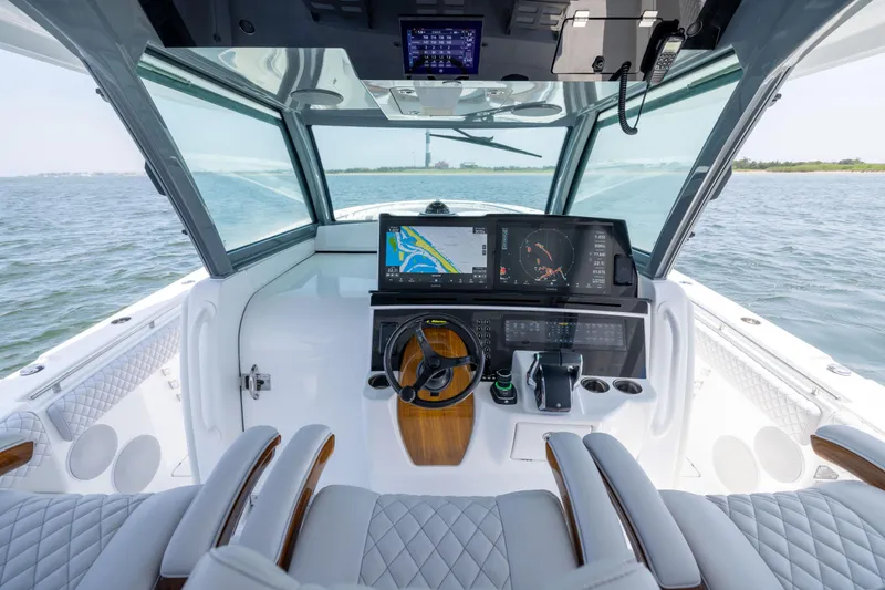 Slide: The Image of Interior view of 2026 HCB 48 Campeon boat cockpit with advanced navigation system. - 14