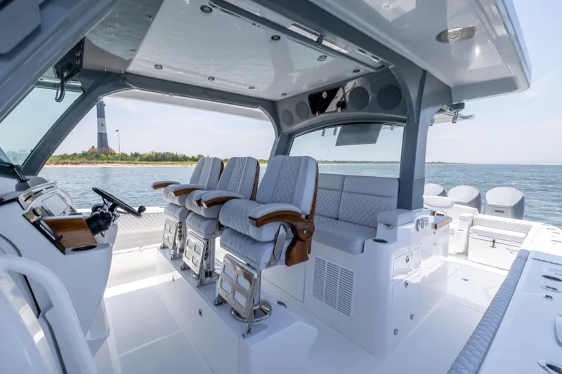 Slide: The Image of 2026 HCB 48 Campeon luxury boat interior with plush seating and ocean view. - 18