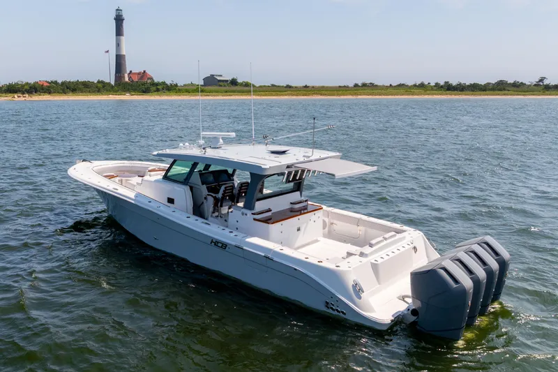 Slide: The Image of 2026 HCB 48 Campeon boat on open water, showcasing sleek design and spacious deck. - 2