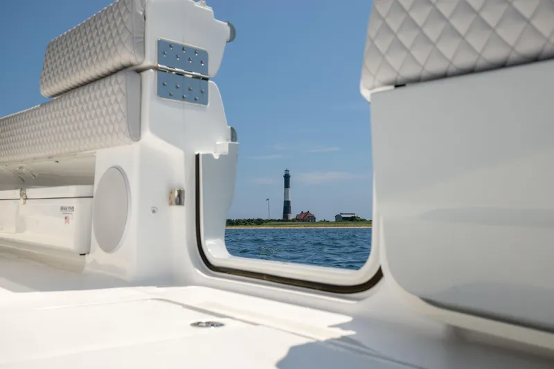 Slide: The Image of HCB 48 Campeon 2026 boat interior with lighthouse view on the water. - 23