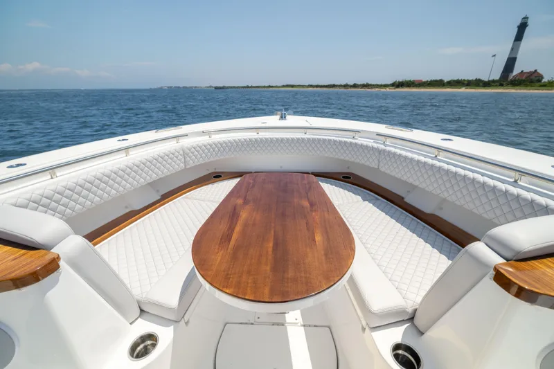 Slide: The Image of Luxurious 2026 HCB 48 Campeon boat interior with elegant seating and wooden table. - 31