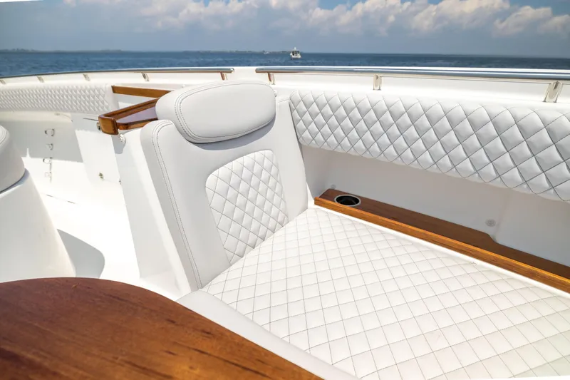 Slide: The Image of Luxurious seating on 2026 HCB 48 Campeon yacht with quilted upholstery and wooden accents. - 32