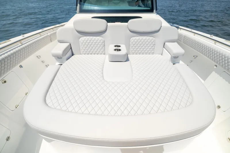 Slide: The Image of Luxurious seating on 2026 HCB 48 Campeon boat with quilted upholstery and cup holders. - 33