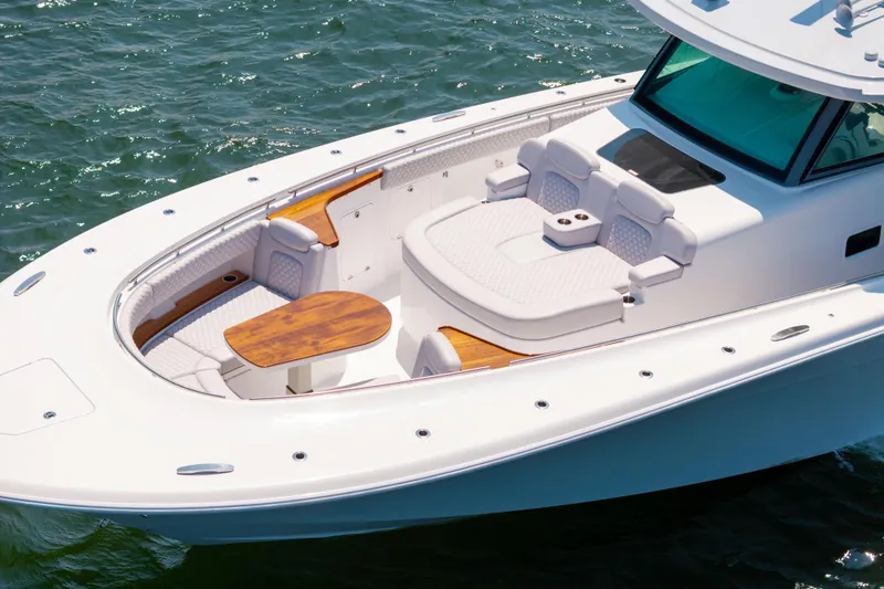 Slide: The Image of Luxurious 2026 HCB 48 Campeon boat with elegant seating and wooden table on open water. - 35