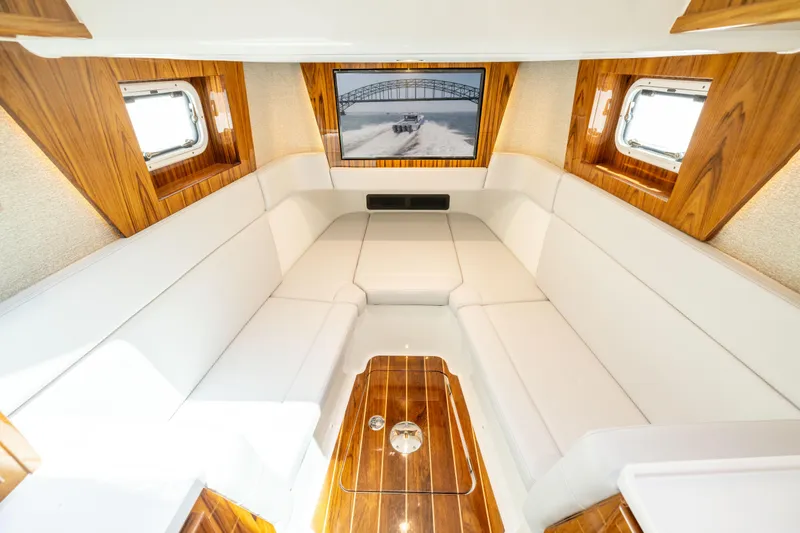 Slide: The Image of Luxurious interior of 2026 HCB 48 Campeon yacht with white seating and wood accents. - 38
