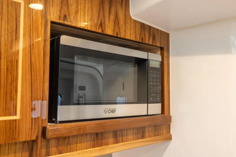 Slide: The Image of Built-in microwave in HCB 48 Campeon 2026 boat's wooden interior. - 40