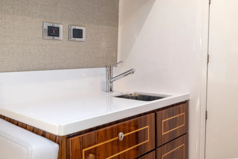 Slide: The Image of Luxurious kitchenette in 2026 HCB 48 Campeon yacht with sleek sink and wooden cabinetry. - 41