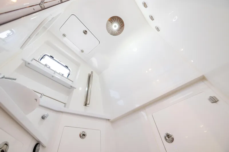Slide: The Image of Interior of 2026 HCB 48 Campeon boat, featuring sleek white bathroom design. - 44