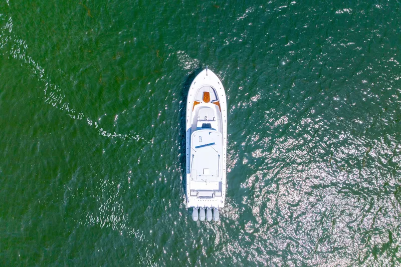 Slide: The Image of Aerial view of 2026 HCB 48 Campeon boat cruising on green water. - 46