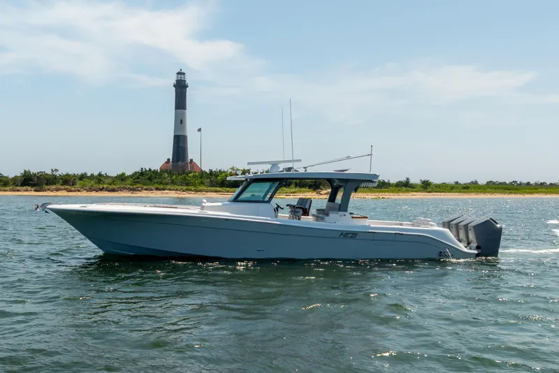 Slide: The Image of HCB 48 Campeon 2026 boat on water near lighthouse and shoreline. - 5