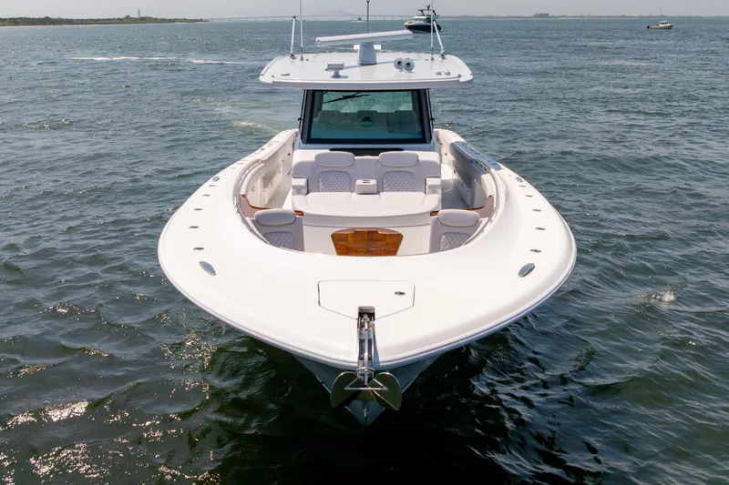 Slide: The Image of HCB 48 Campeon 2026 boat cruising near a lighthouse on a sunny day. - 6