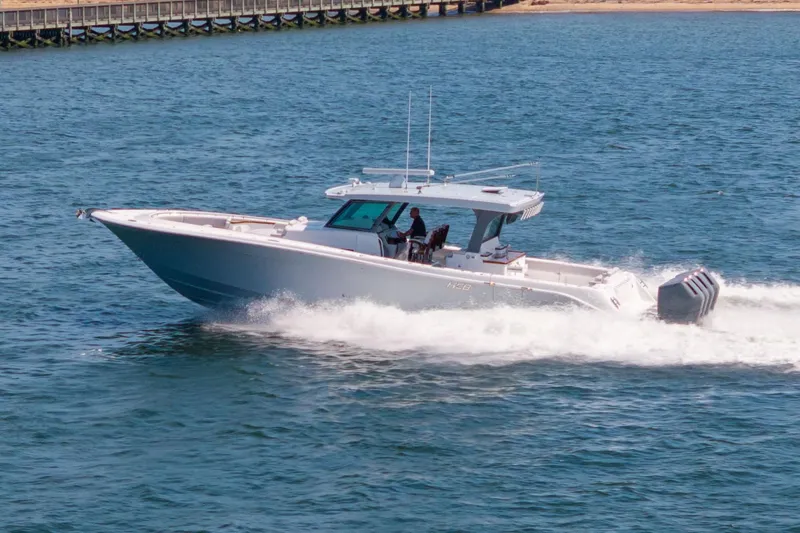 Slide: The Image of 2026 HCB 48 Campeon boat cruising on open water, showcasing sleek design and powerful engines. - 7