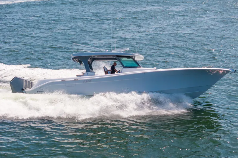 Slide: The Image of 2026 HCB 48 Campeon boat cruising on open water, showcasing sleek design and performance. - 9