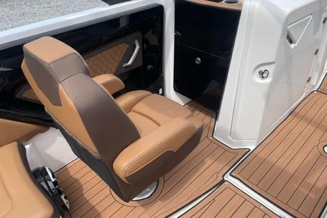 Slide: The Image of 2025 Yamaha Boats 252S interior with tan seating and wood-style flooring. - 10