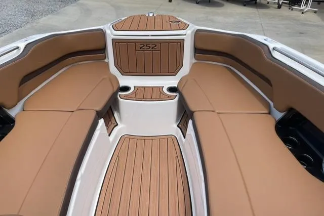 Slide: The Image of 2025 Yamaha Boats 252S interior with tan seating and wood accents. - 12