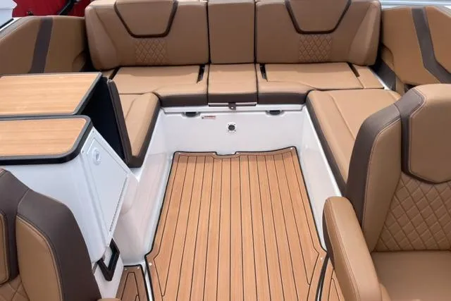 Slide: The Image of 2025 Yamaha Boats 252S interior with tan seating and wood-style flooring. - 8